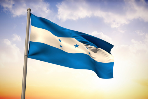 Honduras national flag against beautiful orange and blue sky