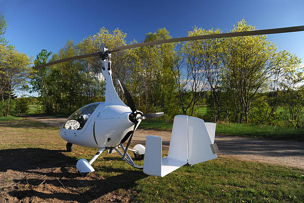 istock White gyroplane parked on the private airfield 487745451