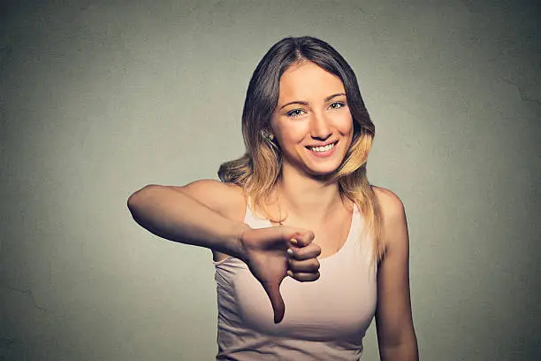 Photo of sarcastic woman showing thumbs down happy someone made mistake failed