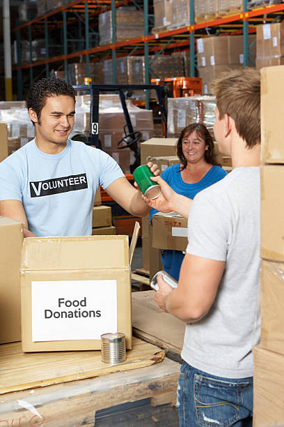 istock Volunteers Collecting Food Donations In Warehouse 487746351