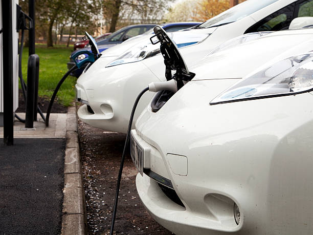Morpeth, England - April 26, 2014: Two Nissan Leaf electric cars, owned by the local council in Morpeth, being recharged at the council car park.