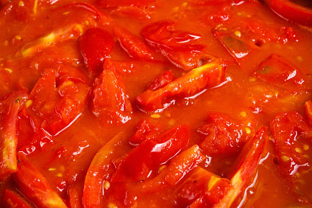 istock bunch of fresh red tomatoes sliced stewed in a pan 487749146