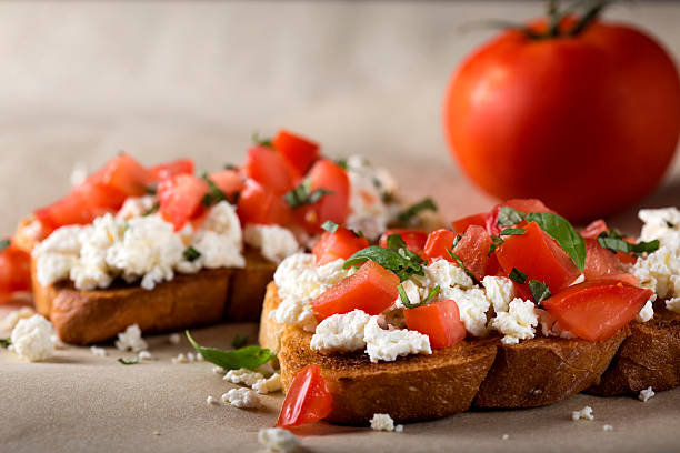 istock Bruschetta with roasted tomatoes, cheese and herbs 487755394