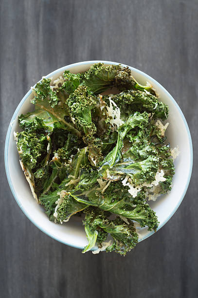 istock Homemade curly kale chips sprinkled with parmesan cheese 487755930