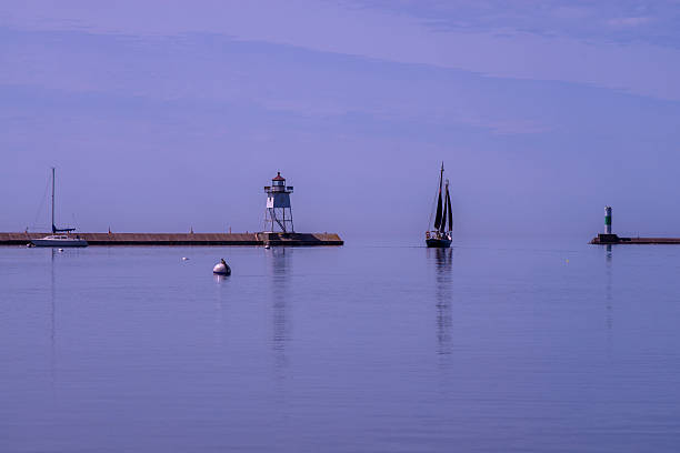 istock calm sailing, grand marais lighthouse 487758752
