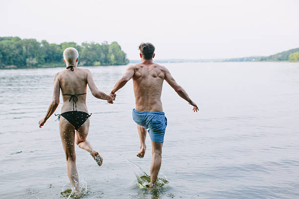 istock Good friends running into the lake 487764676
