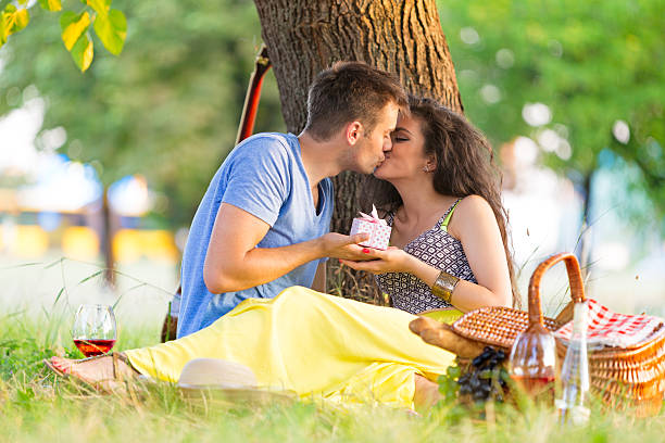 istock Couple having picnic in the park 487765370