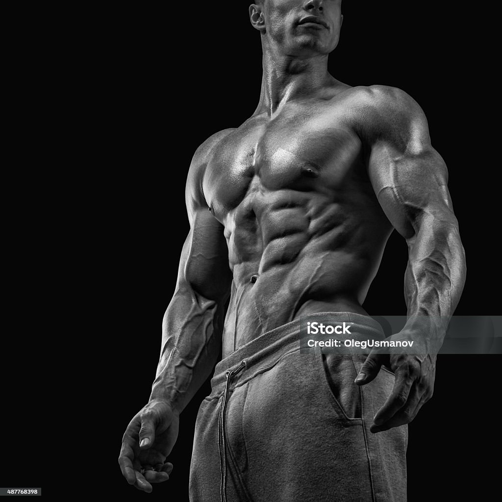 Close-up of athletic muscular man Strong and handsome young man with muscles and biceps. Close-up of a power fitness man. Black and white photo Body Building Stock Photo