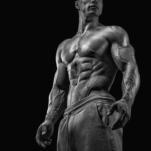 Close-up of athletic muscular man Strong and handsome young man with muscles and biceps. Close-up of a power fitness man. Black and white photo body building stock pictures, royalty-free photos & images