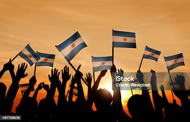 Silhouettes Of People Holding Flag Of Argentina Stock Photo - Download Image Now - Argentinian Flag, Celebration, People