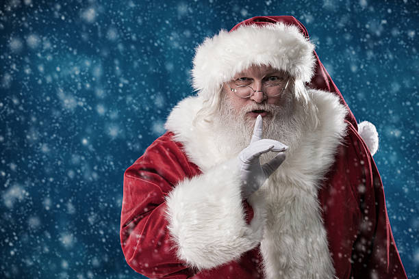 real santa com o dedo para os lábios - finger on lips whispering secrecy silence imagens e fotografias de stock