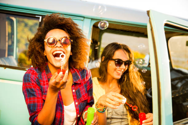 istock Friends blowing bubbles on roadtrip 487772663