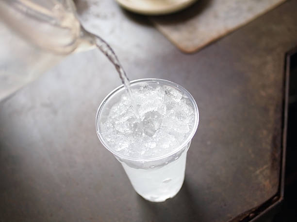 pouring fresh water to glass of ice