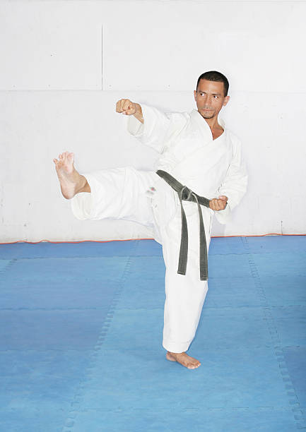 istock Man in a kimono hits with foot and hand. 487773619
