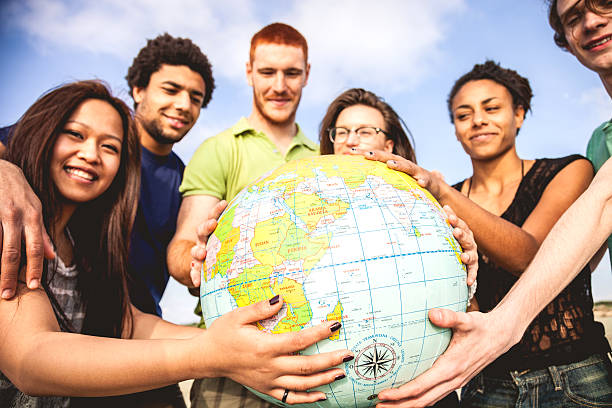 istock Group of friends holding an earth globe 487774531