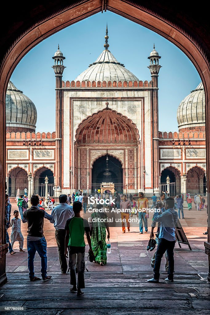 Tourists admirer sites of Jama Masjid in Old Delhi Old Delhi, India - March 9, 2014: Local and foreign tourists enjoy the view of Jama Masjid mosque in Old Delhi Jama Masjid in Old Delhi. Arch - Architectural Feature Stock Photo