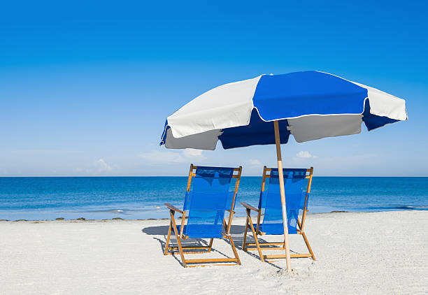 istock sun loungers and a beach umbrella on silver sand 487780819