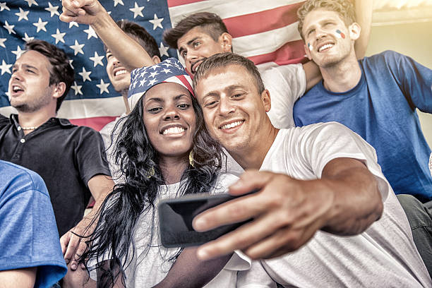 istock Young couple taking a selfie at the stadium 487782241