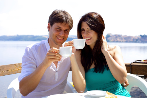 Cute happy couple drinking cappuccino