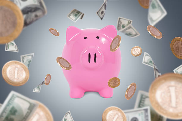 istock Dollar Banknotes and Coins Falling Around Piggy Bank 487785203