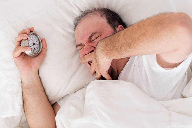 istock Man yawning as he tries to wake up 487785761