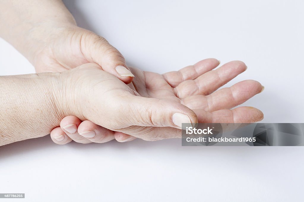 Woman hands over a white background Elderly woman suffers from muscular pains Adult Stock Photo