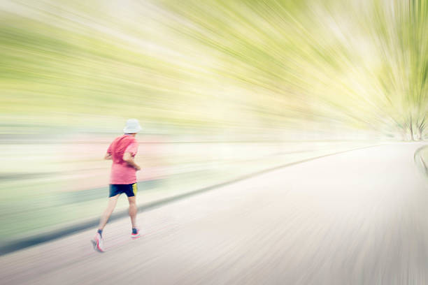 Abstract image of man jogging  in the park,. Motion blur effect.