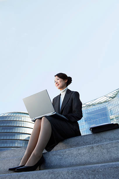 istock Businesswoman Using Laptop On Outdoor Steps 487786833