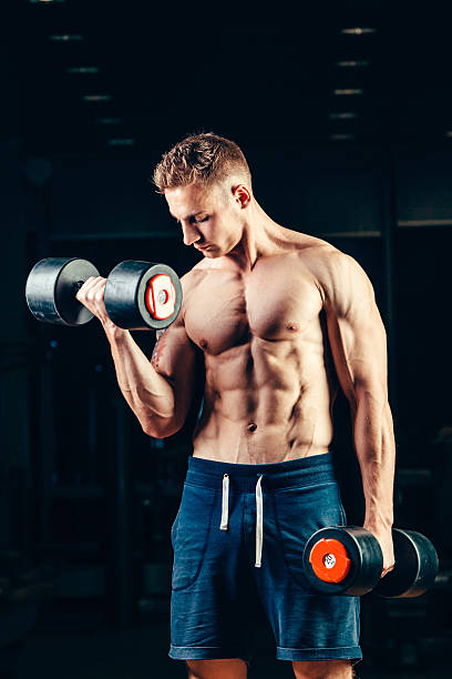istock Athlete muscular bodybuilder training back with dumbbell  in the gym 487787976