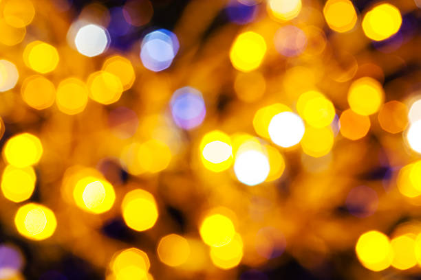 istock dark yellow and violet twinkling Christmas lights 487790512
