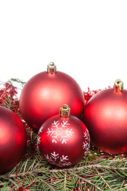 istock red Christmas decorations on green tree branch 487790526