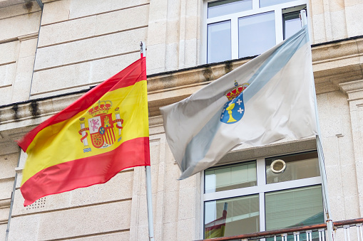 Spain and Galicia flags waving in the wind