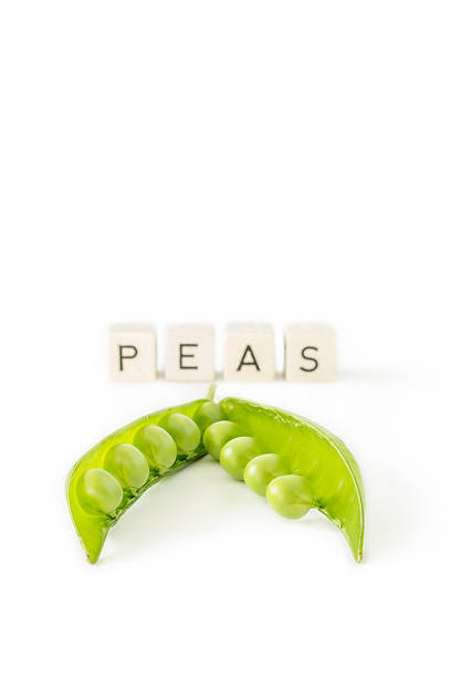 Green peas isolated on white background with letters