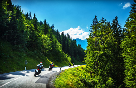 Bikers in mountainous tour, travelling across Europe, curve highway in mountains, scene destinations, extreme transport, active lifestyle