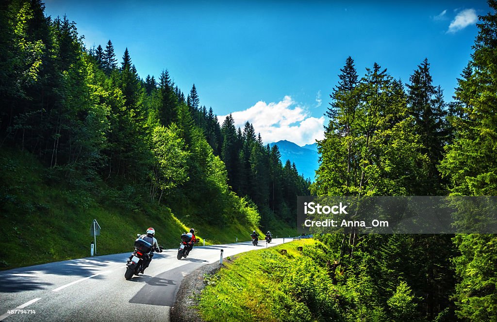 Bikers in mountainous tour Bikers in mountainous tour, travelling across Europe, curve highway in mountains, scene destinations, extreme transport, active lifestyle Motorcycle Stock Photo