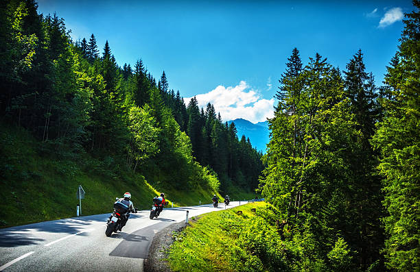 Bikers in mountainous tour Bikers in mountainous tour, travelling across Europe, curve highway in mountains, scene destinations, extreme transport, active lifestyle motorcycle racing stock pictures, royalty-free photos & images