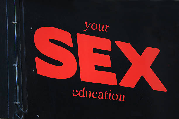 ''you sex education'' sign on a black backgound