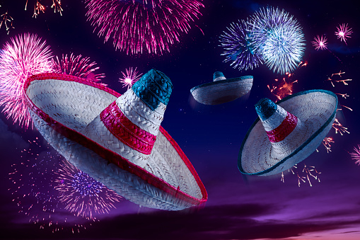Mexican sombreros with fireworks at night