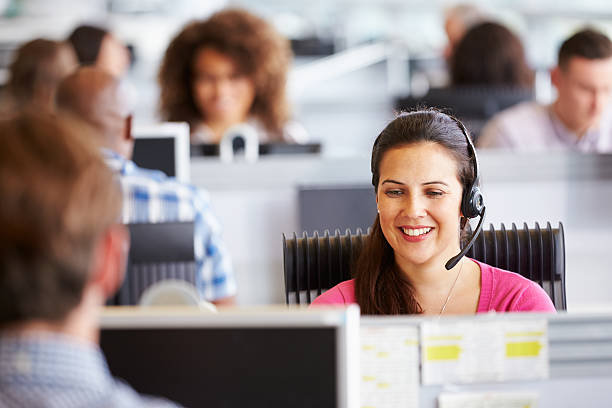 istock Young woman working in call centre, surrounded by colleagues 487798186