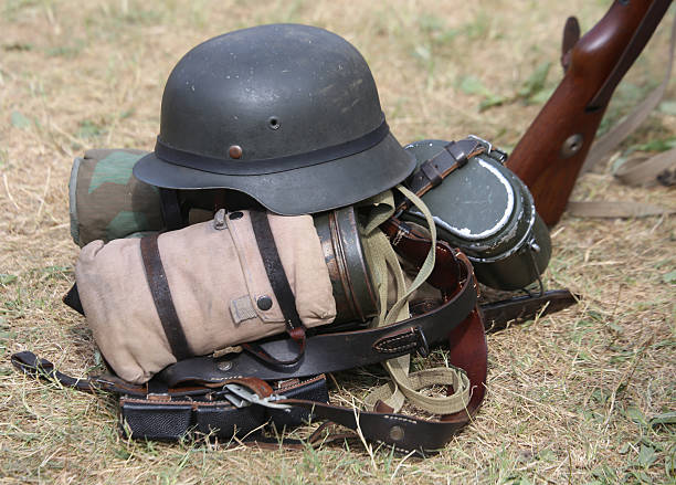 istock helmet with a rifle in the army camp 487800378