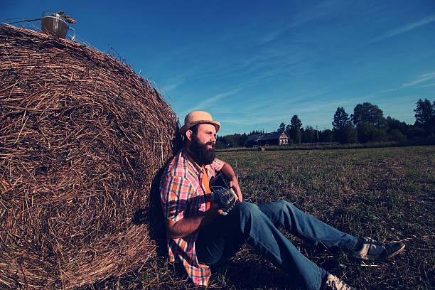 istock man with guitar and beer on the nature 487801352