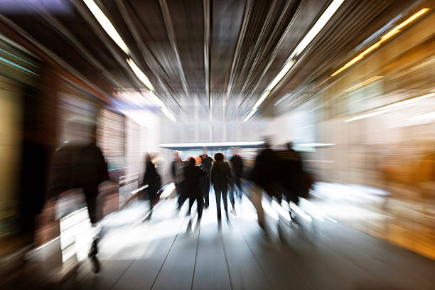 istock Motion Blurred Group of People Walking Down Shopping Passage 487804422