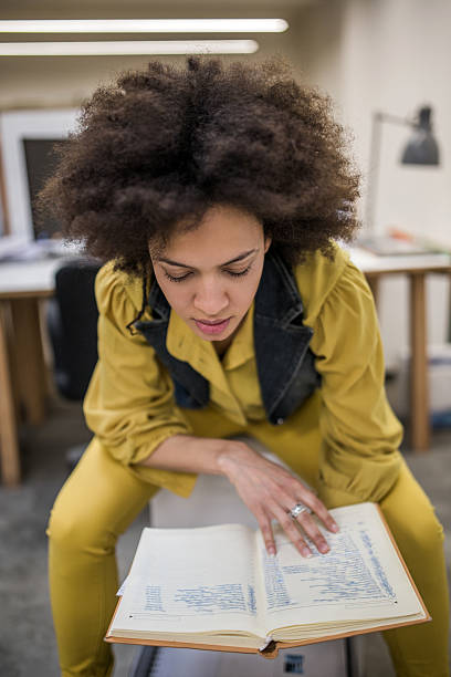 istock Creative African American woman in office reading documents. 487804766