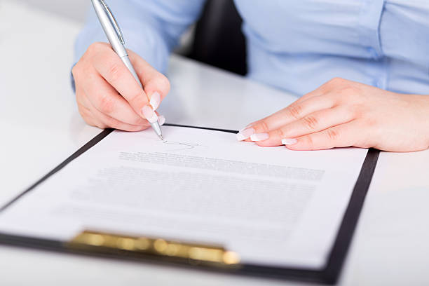 istock Young woman signs a contract 487805623