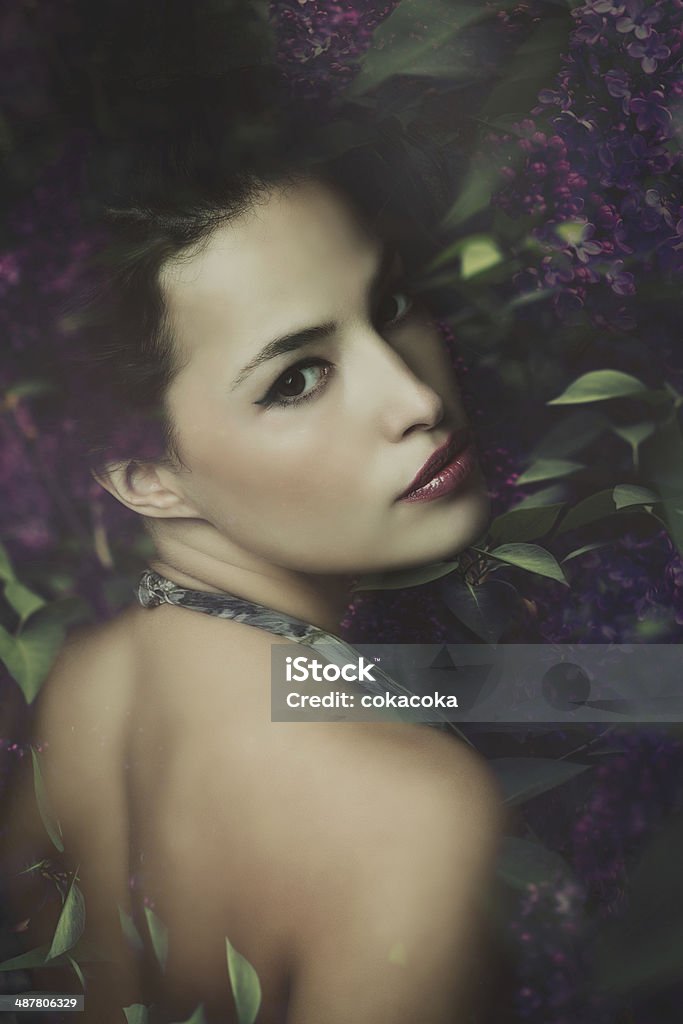 fairy woman like a fairy in lilac flowers, composite photo Adult Stock Photo