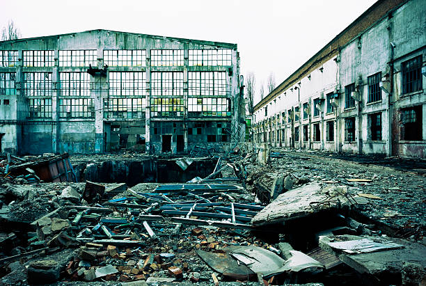 istock Destroyed, abandoned industrial building and courtyard on crisis time. Toned. 487807509