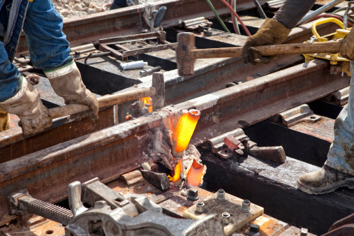 Railroad Thermite Welding Process, Excess steel and mould material is removed, Cleaned of all debris,Rail Fusion,Reconstruction,   Forge,Mold,Alloy,Heat,Industrial Tools