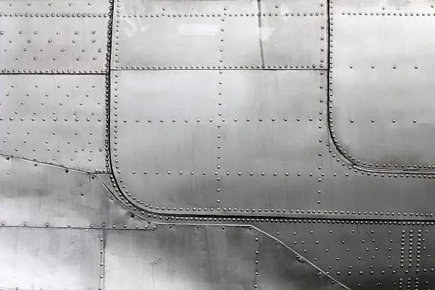 Aluminum fuselage and rivets in old airplane.