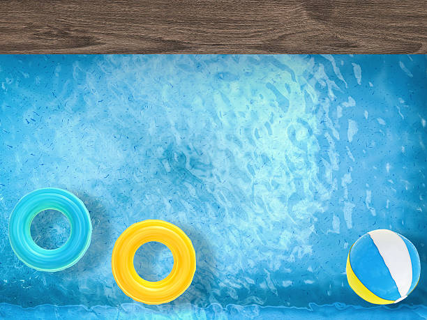 istock pool top view with swim rings and beach ball 487808126