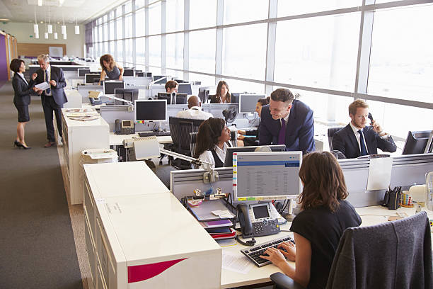 istock Manager in discussion with coworker in an open plan office 487808502